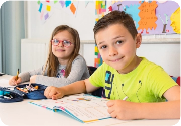 Two kids focused on learning